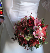 Passionate red roses, lilies, alstromeria, and pepper berri