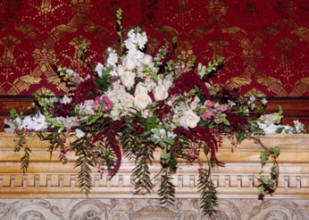 A mantle bouquet in red, pink, and white