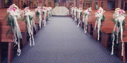 Pink and white aisle decorations