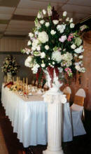 Altar bouquets frame the receptoin head table